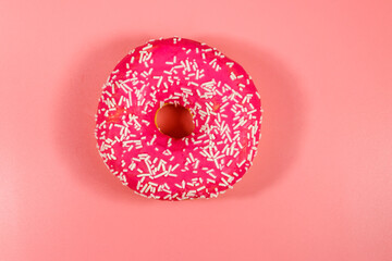 Tasty pink donut on pink background