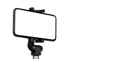 Smartphone with a white cut-out screen on a monopod. Selfie stick and smartphone on a white background.