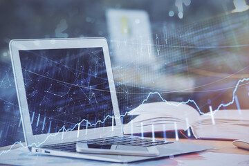 Forex graph hologram on table with computer background. Double exposure. Concept of financial markets.