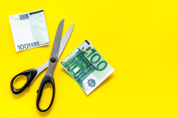 Decline of euro exchange rate. Scissors cut dollars banknote