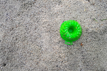 Sand toy on beach. Closeup pastic colorful toy for child. SToy items on the sand. childhood concept.