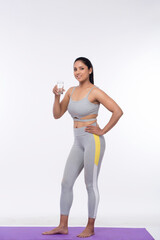 Fitness woman drinking water isolated on white background.