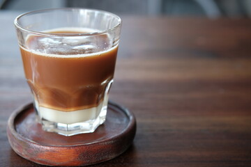 A Cup of coffee on the table with wooden background