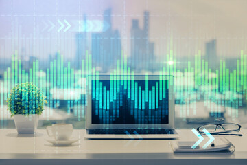 Stock market graph on background with desk and personal computer. Multi exposure. Concept of financial analysis.