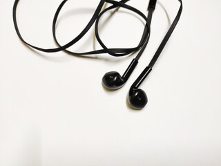 Top view of black earphone isolated on white background with space for text