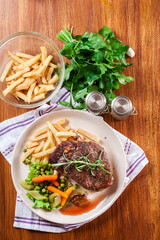 Beef steak served with baked potatoes