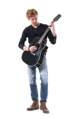 Young handsome guitarist man playing acoustic guitar looking down and practicing. Full body length isolated on white background. 