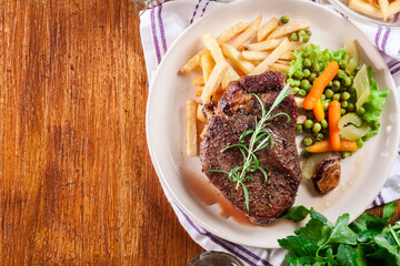 Beef steak served with baked potatoes