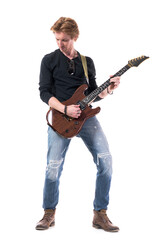 Ginger young handsome rocker guitarist playing electric guitar looking down. Full body length...