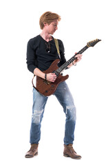 Naklejka premium Cool relaxed young rocker guitarist man practicing and rehearsing electric guitar. Full body length isolated on white background. 
