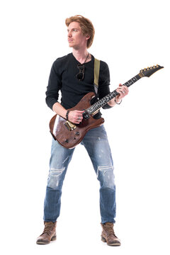 Cool Handsome Confident Young Rock Music Guitarist Playing Electric Guitar Looking Up. Full Body Length Isolated On White Background. 