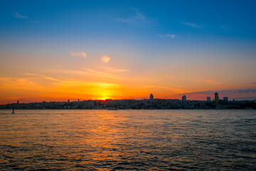 Beautiful sunset over the Bosphorus Bridge, Istunbul, Turkey. Silhouette of resort town.