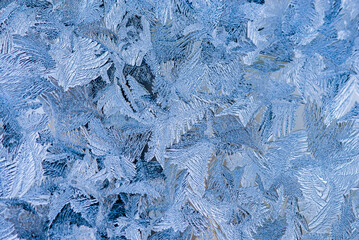 Nice frost pattern on glass in cold temperature colors for summer heat, abstract background
