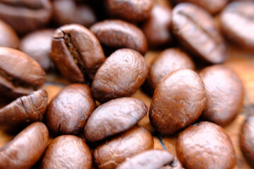 close up coffee beans on wood table and macro coffee beans background