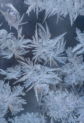 Nice frost pattern on glass in cold temperature colors for summer heat, abstract background