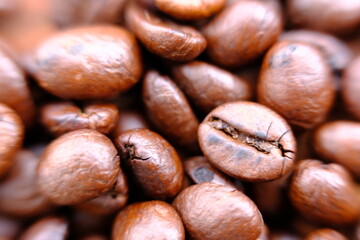 close up coffee beans on wood table and macro coffee beans background