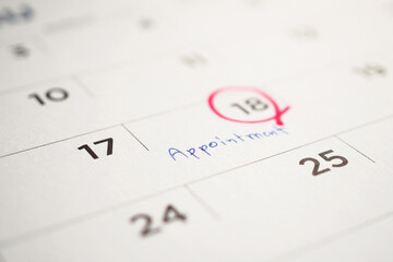 important appointment schedule write on white calendar page date close up