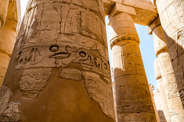 Egyptian hieroglyphics on pillars in central colonnade of temple, Karnak in Luxor, Egypt