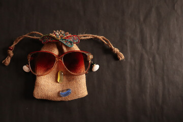 Sack art of a girl created using a jute sack by sunglasses, crown and stones for showcasing a...
