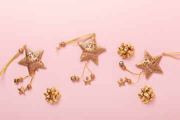 Christmas flat lay composition. Gold decoration on pink background. Horizontal banner