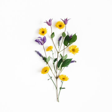 Flowers composition. Yellow and purple flowers on white background. Flat lay, top view