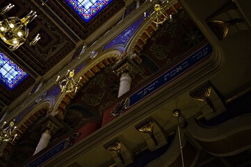 Obraz premium Prague, Czech Republic - 30 December 2019: interior of the Jeruzalémská synagoga wich has a Moorish style with many chadeliers, oriental arches, golden decorations and biblical verses on the wall