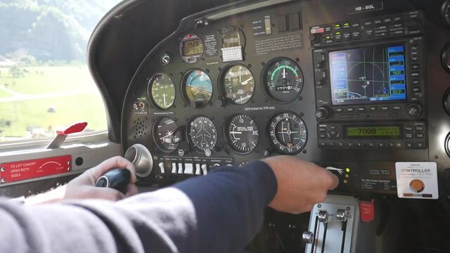 Close up cockpit avionics bay. Pilot piloting a small plane. Flying over Switzerland.
