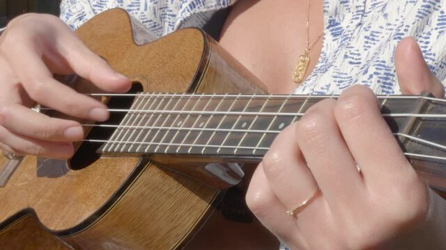 A person playing the Ukulele - close up