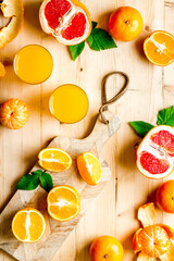 Fresh orange juice and citrus fruits, top view
