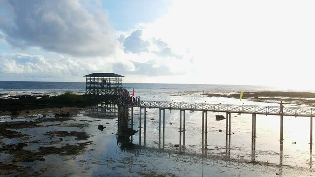 Drone shot of people walking on the plankway of the Cloud9 surfing tower