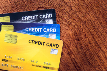 Fototapeta premium Close up credit card on the wooden table for making debit payment and shopping on banking for background. 