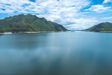 Beautiful nature scenic landscape with mountain range clear view on blue sky in the morning at Vajiralongkorn Dam, Kanchanaburi, Thailand.