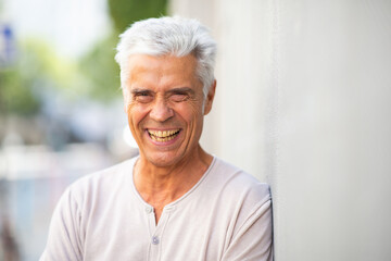 Fototapeta na wymiar Close up handsome elderly man smiling outside