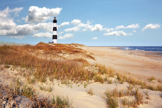 The lighthouse with seashore landscape background in Outerbanks NC, USA. Soft blurry background. 