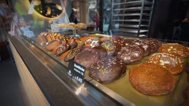 Shop window of a candy store shows homemade decorated gingerbread in various forms