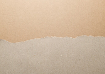 Wrapping gray paper with torn edges.Torn white and brown paper background.Craft paper background, top view and close up.
