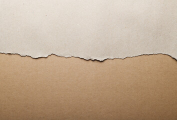 Wrapping gray paper with torn edges.Torn white and brown paper background.Craft paper background, top view and close up.
