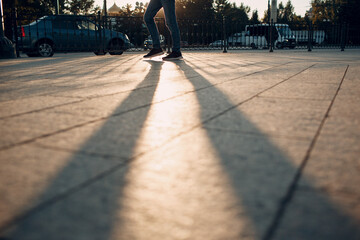 Legs and shadow of pedestrian on city street