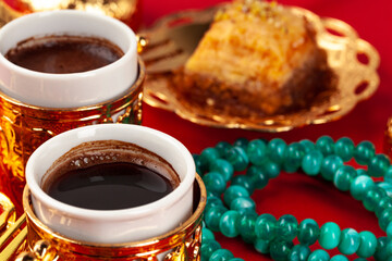 Turkish coffee in a golden oriental cup on red background