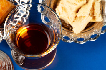 Halva dessert with tea cup on blue background