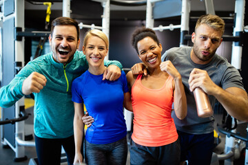 Fototapeta premium Attractive sports people friends are working out in gym
