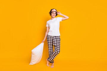 Full length photo of cute pretty girl hold soft pillow ready healthy sleep wear pants t-shirt eye mask isolated over vibrant color background