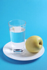 Green apples and glass of water