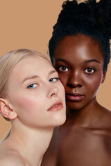 The real beauty exists in every corner of the world and is presented by women of all races. Cropped portrait of two beautiful ladies with different skin and hair colour posing cheek to cheek. 