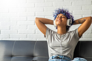 girl or woman at home listening to music with headphones