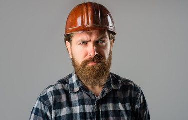 Bearded worker in hard hat. Builder concept. Building, industry, technology. Builder in hard hat. Portrait of bearded workman. Side view portrait. Tired man. Advertising.