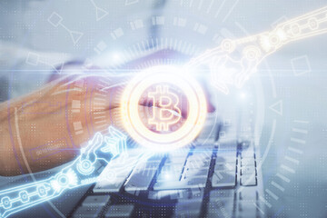 Crypto currency theme hologram with businessman working on computer on background. Concept of blockchain. Multi exposure.