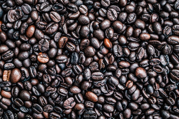 Brown roasted whole coffee beans background. Dark roast for your brewing method. Seed nature from above view. Group agriculture grain arabica. Photos from the top view.