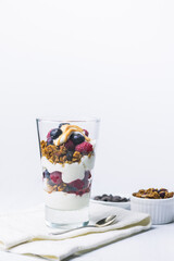 Yogurt dessert with granola, blueberry, raspberry and chocolate on the top.