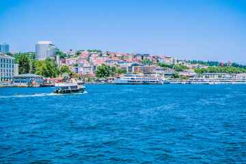 Fototapeta premium Beautiful scenery port with sightseeing boats in Istanbul background. Resort town side in Bosphorus Bridge, Turkey.